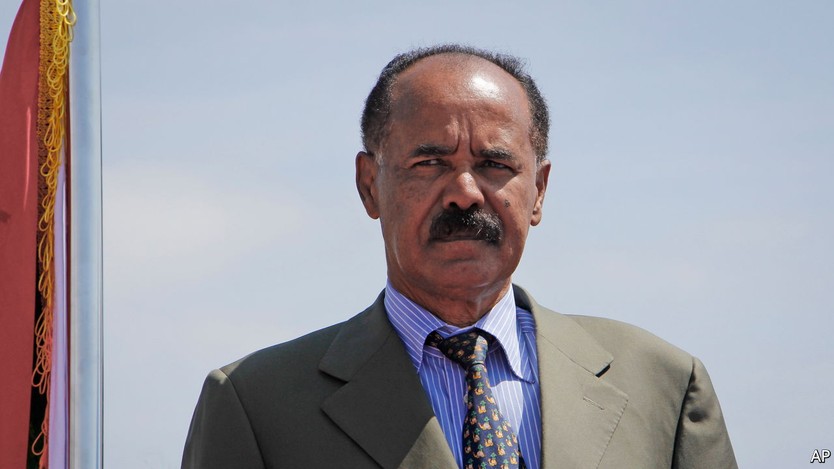 Eritrea's President Isaias Afwerki stands for a military parade after being welcomed by Somalia's President Mohamed Abdullahi Mohamed upon his arrival at the airport in Mogadishu, Somalia Thursday, Dec. 13, 2018. The official visit is part of the consultative Tripartite Summits of the Heads of State and Government of Eritrea, Ethiopia and Somalia, according to Eritrea's Minister of Information. (AP Photo/Farah Abdi Warsameh)