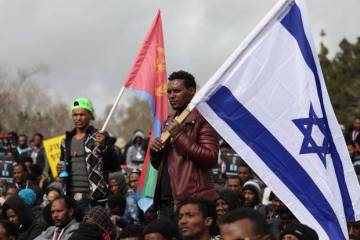 Eritrean refugees in Israel protest with Israeli and Eritrean flags