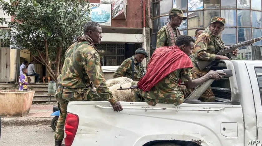 Members of the Amhara militia that sides with federal and regional forces against the northern region of Tigray ride on the back of a pick up truck in the city of Gondar, Ethiopia, Nov. 8, 2020.