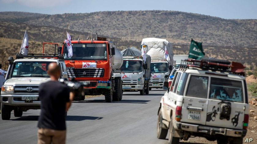 A convoy of trucks from Medecins Sans Frontieres (Doctors Without Borders) carrying medical supplies stops by the side of the…