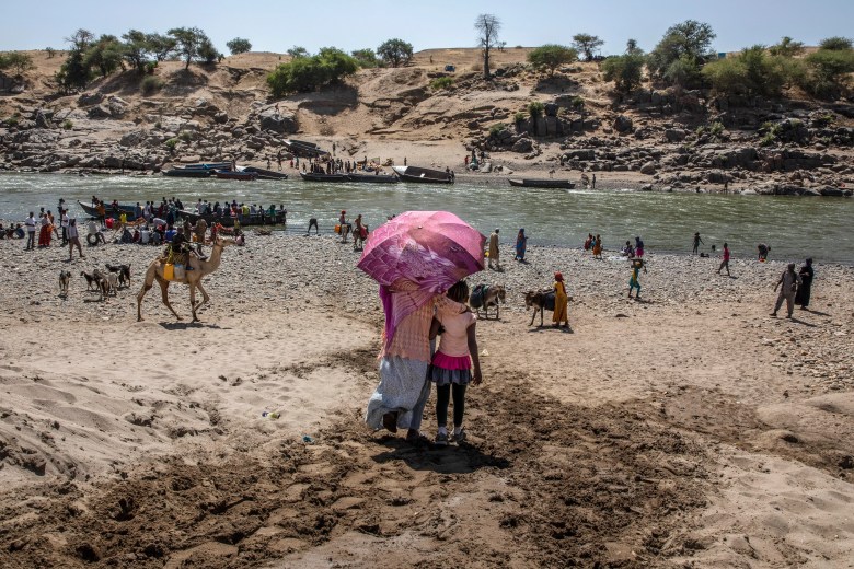 FILE – In this Nov. 21, 2020, file photo, refugees who fled the conflict in Ethiopia’s Tigray region arrive on the banks of the Tekeze River on the Sudan-Ethiopia border, in Hamdayet, eastern Sudan. Huge unknowns persist in the deadly conflict, but details of the involvement of neighboring Eritrea, one of the world’s most secretive countries, are emerging with witness accounts by survivors and others. (AP Photo/Nariman El-Mofty, File)