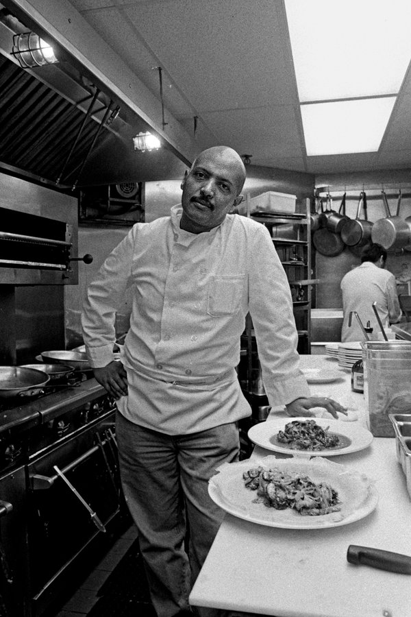 Ficre Ghebreyesus in 2000 at Caffe Adulis in New Haven, where he introduced diners to the cuisine of his native Eritrea. Many learned only after his death that he was a painter, too. Like his cooking, his art was “something remembered, something invented,” said his widow, the poet Elizabeth Alexander.